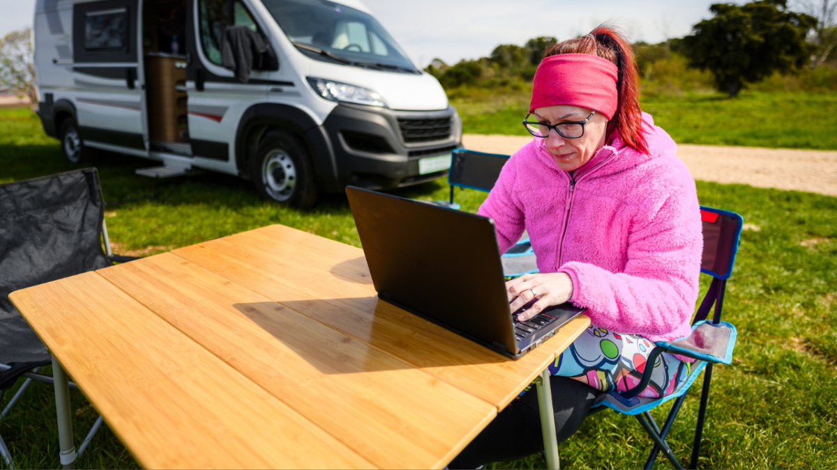 Working on a laptop at a campsite