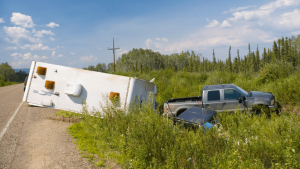 A truck and trailer in the ditch