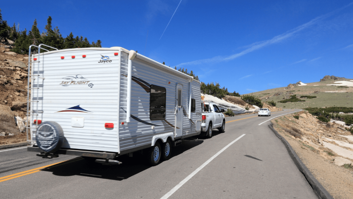 Truck pulling a travel trailer through Rocky Mountain National Park