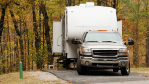 A fifth wheel and truck at a campsite