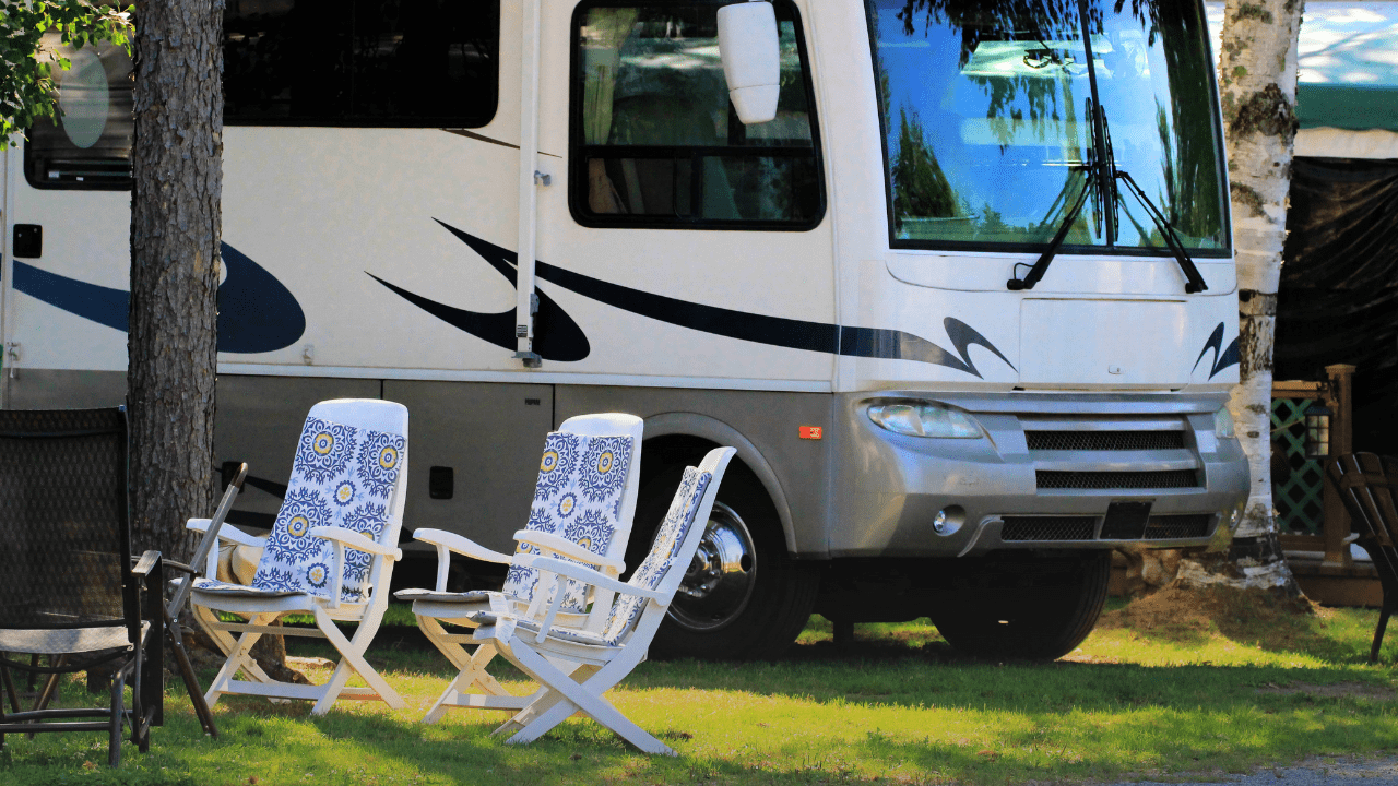 A motorhome and camping chairs at an adult-only campground
