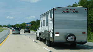 The Aspen Trail camper trailer pulled by a pickup truck