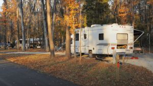 An older Class-C motorhome at a campground