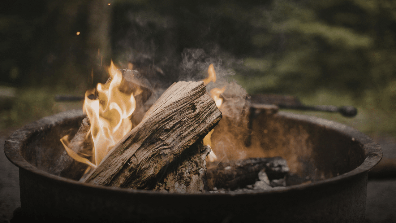 A campfire in a metal firepit ring