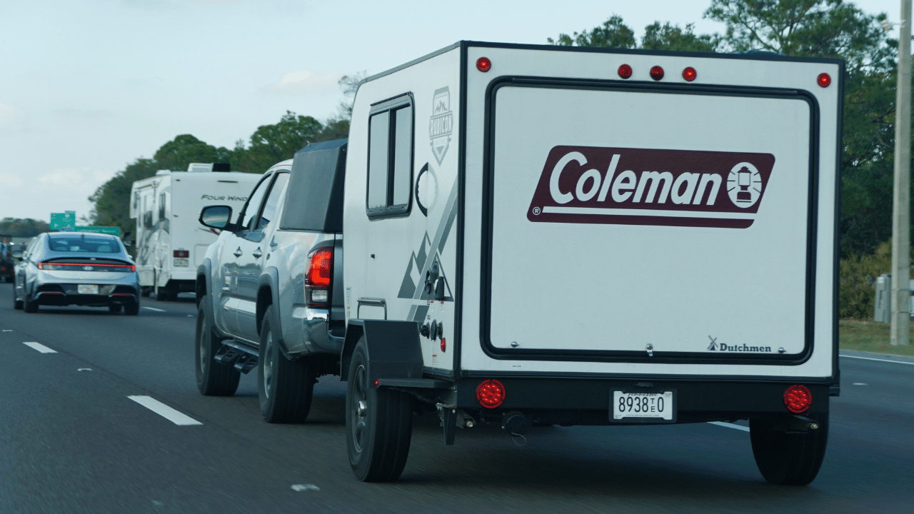 A Coleman trailer towed on highway