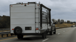 A truck pulling a travel trailer down the highway