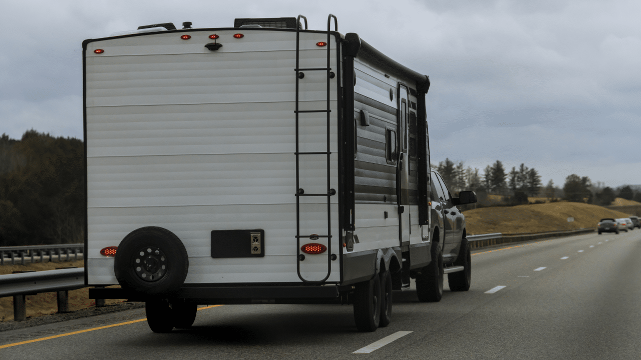 A truck pulling a travel trailer down the highway
