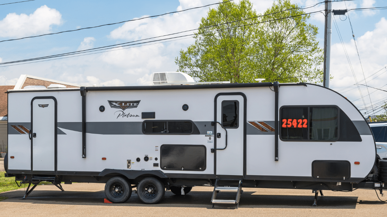A new Forest River X-Lite Platinum travel trailer displayed outdoors at an RV dealership