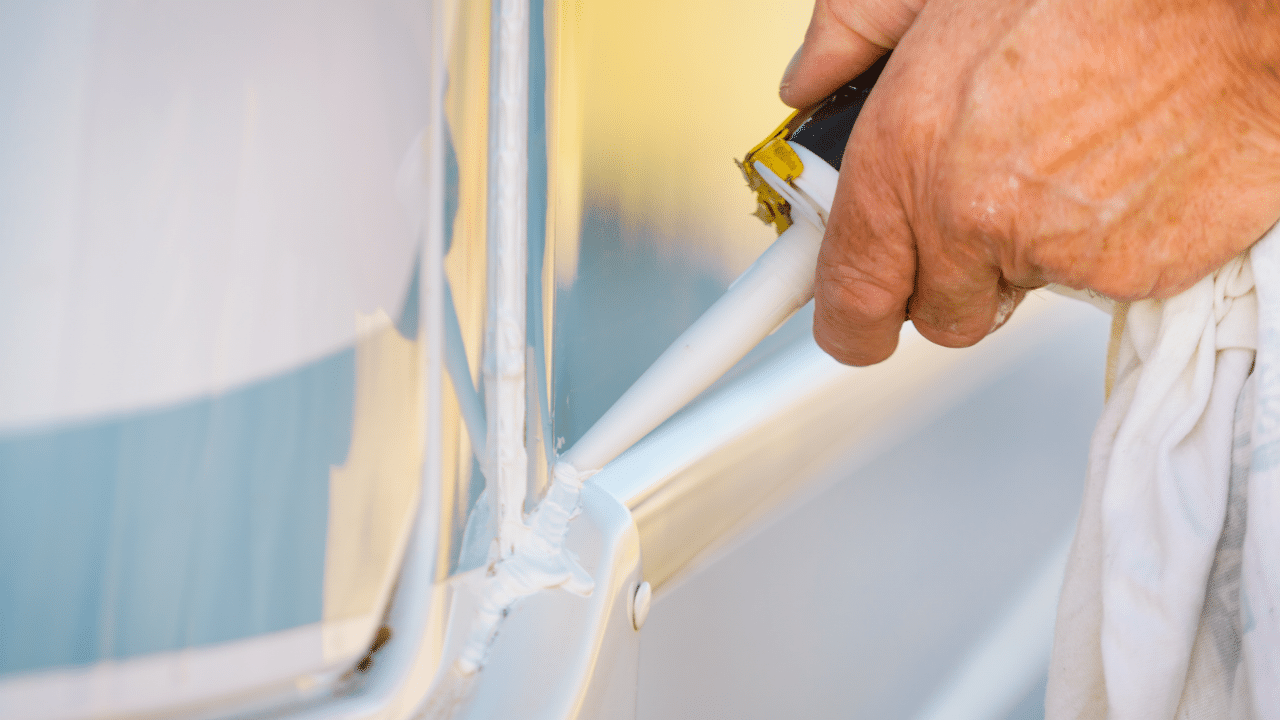 Man applies sealant to an RV