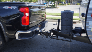 A Chevrolet Silverado 4X4 pickup truck towing travel trailer with hitch assembly
