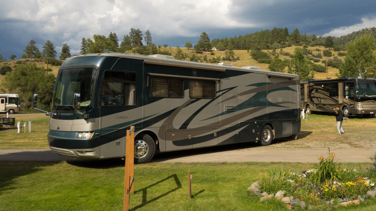 A Class-A motorhome backing into a campsite
