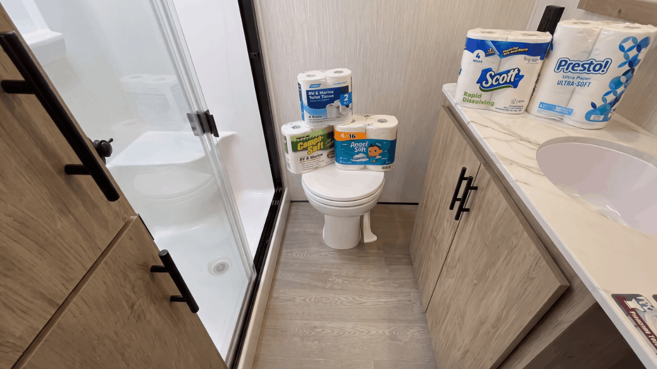 An RV bathroom with different brands of toilet paper displayed