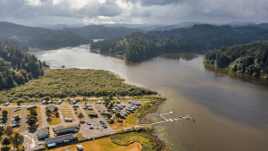 Aerial view of RV parking and a boat ramp along Tenmile Lake in Lakeside, Oregon
